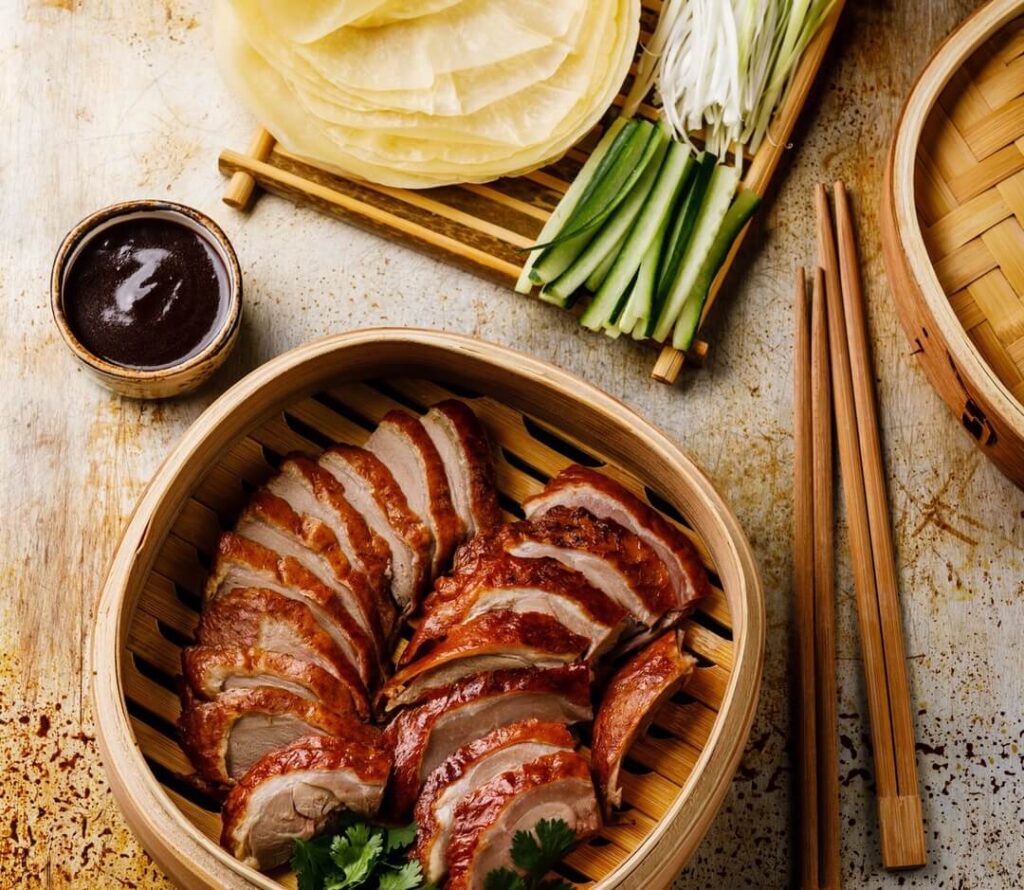 Peking Duck, crispy roasted duck dish served with thin pancakes